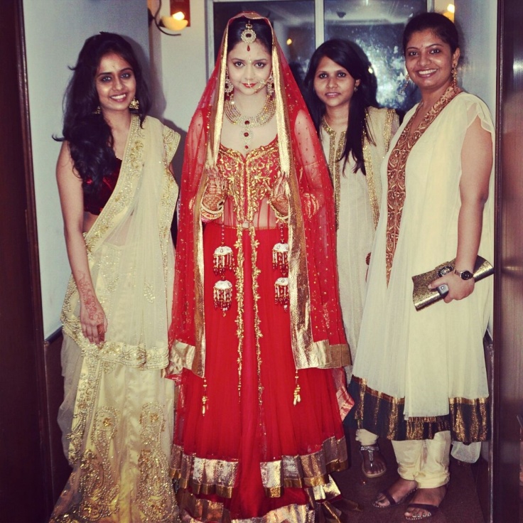 Indian Bride in red wedding lehenga going for jaimaal